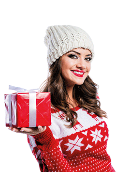 A woman in a festive jumper with a wrapped gift